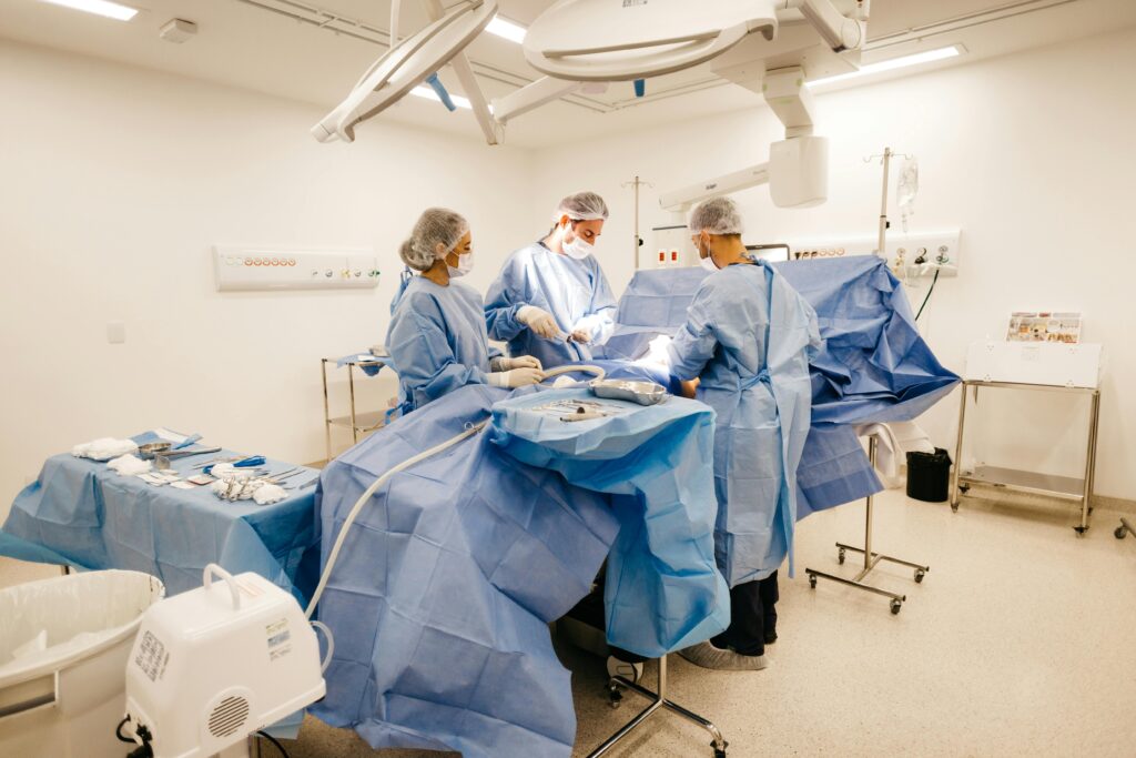 Medical professionals conduct surgery in a sterile, well-equipped operating room.